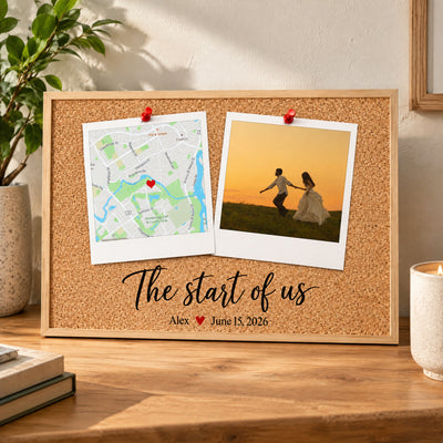 Personalized Polaroid Map and Photo Poster standing on a wooden table beside a plant, candle and books