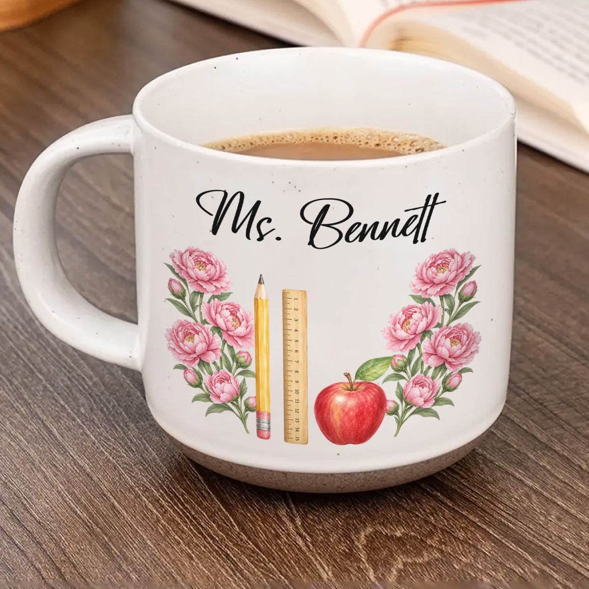 Personalized pottery mug custom teacher name white mug with pink peonies, pencil, ruler and apple, coffee inside, on a desk