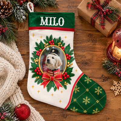 Personalized Christmas stocking custom name photo laid flat on wood with a gift, pinecones, a knit blanket and a lantern