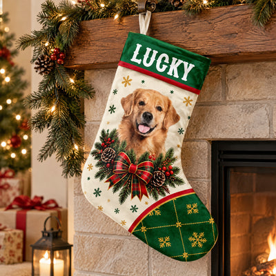 Personalized Christmas Stocking on a wood mantel near a fireplace, lit garland, lantern and Christmas tree in view