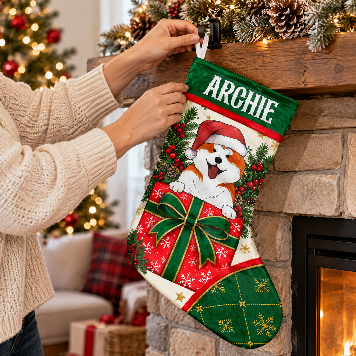 Personalized Christmas stocking with dog being hung on a stone fireplace mantel by hands in a cream sweater