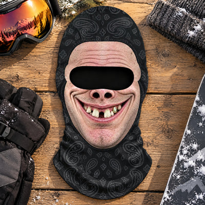Funny Personalized Ski Mask on wood boards beside ski goggles, black gloves, a knit beanie and a snowboard