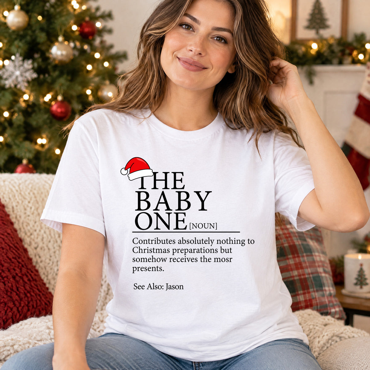 Personalized Christmas Family Matching T-shirt in white worn by woman seated on a couch with holiday pillows