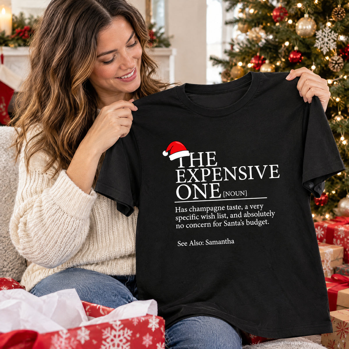 Personalized Christmas Family Matching T-shirt in black held up by smiling woman with wrapped gifts around her