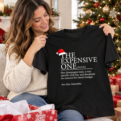 Personalized Christmas Family Matching T-shirt in black held up by smiling woman with wrapped gifts around her