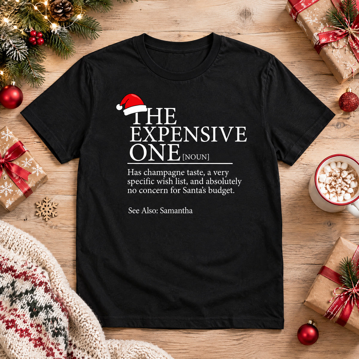 Personalized Christmas Family Matching T-shirt in black laid flat on wood with gifts, ornaments and cocoa