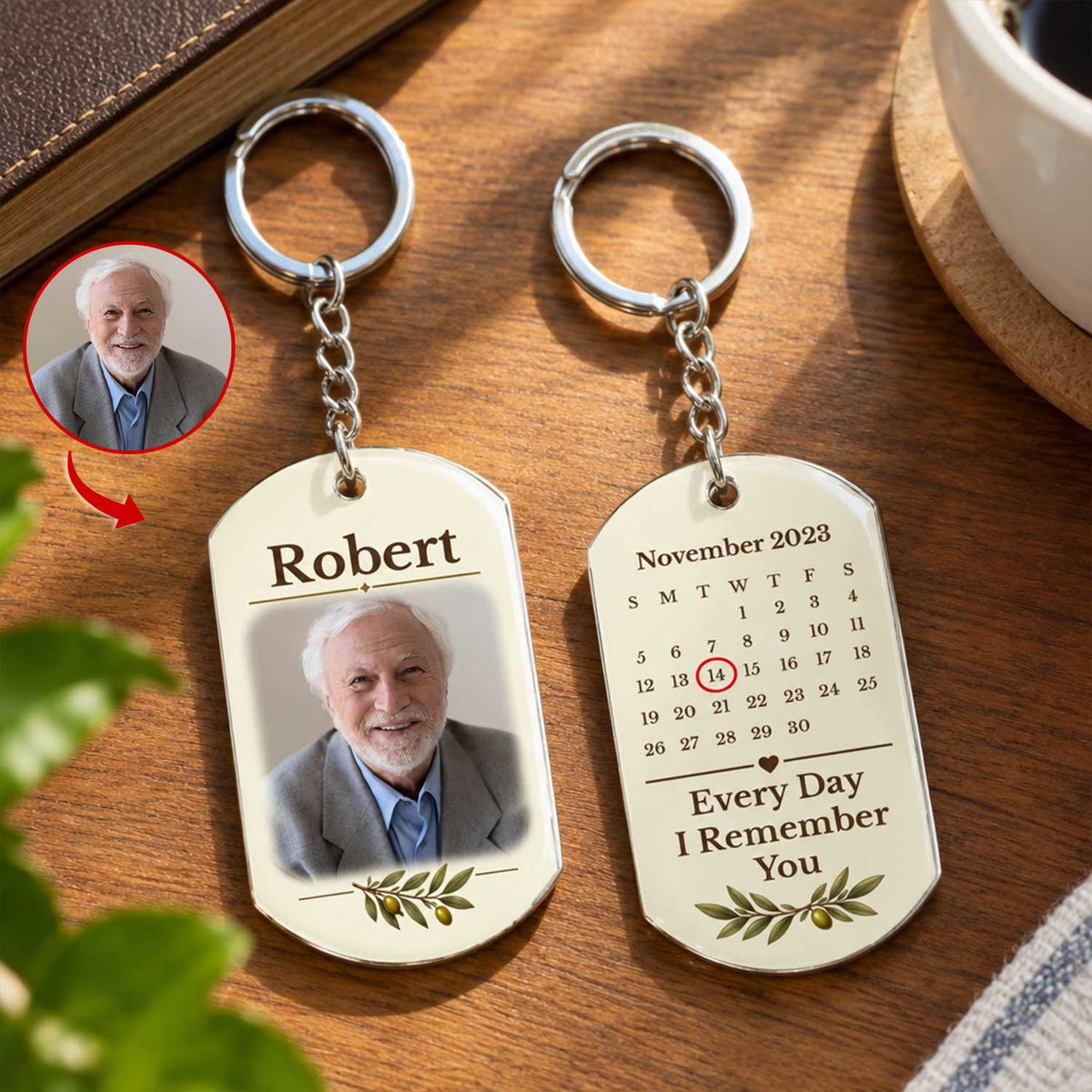 Personalized stainless steel memorial keychain with name and photo side and calendar side in sunlight near a coffee cup