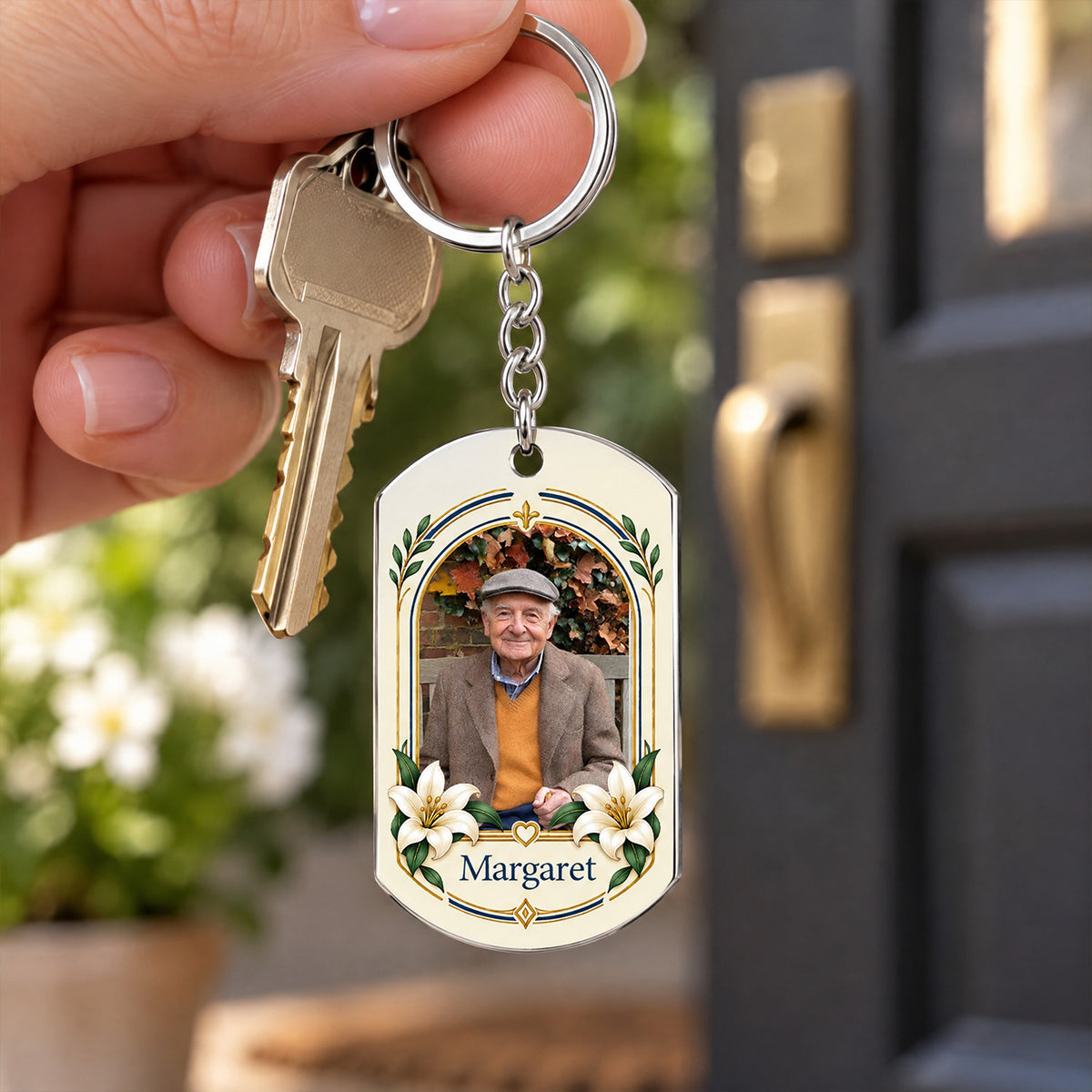 Personalized Stainless Steel Keychain held in a hand beside a house key, with a dark door in the background