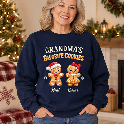 Personalized Crewneck Sweatshirt Gingerbread worn by smiling woman beside a lit Christmas tree, hands in pockets