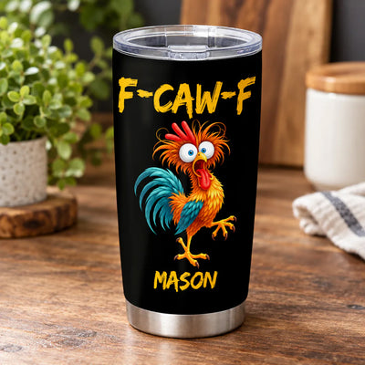 Personalized tumbler custom name rooster design on a wooden counter with a plant and cloth in the background