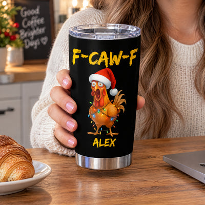 Personalized tumbler custom name rooster design held by a woman in a sweater beside a croissant on a table