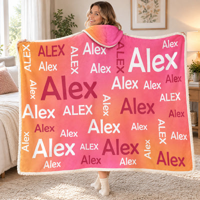 Personalized Wearable Hooded Blanket with Alex names held open by a smiling woman looking over her shoulder in a bedroom