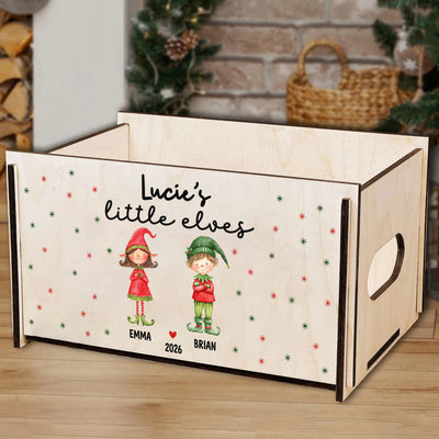 Personalized wooden treasure chest front view on a wood floor, with a side handle cutout and a wicker basket behind